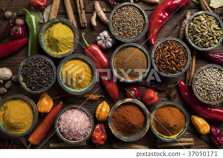 A selection of various colorful spices on a wooden 37050171