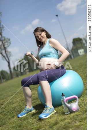 Pregnant woman excercises with gymnastic ball Pregnant woman excercises with gymnastic ball 37050241