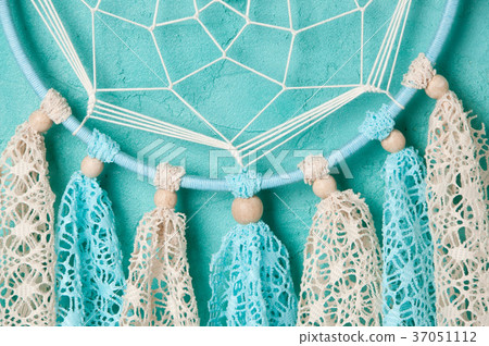 Dream catcher on aquamarine wall background Dream catcher on aquamarine wall background 37051112