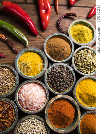 A selection of various colorful spices on a wooden 37051255
