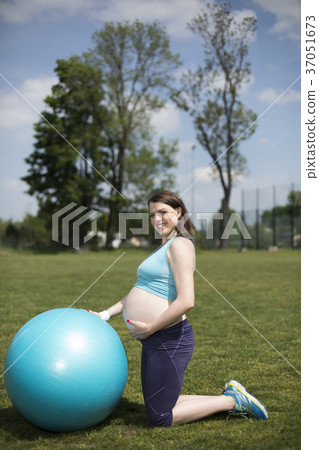 Pregnant woman excercises with gymnastic ball 37051673