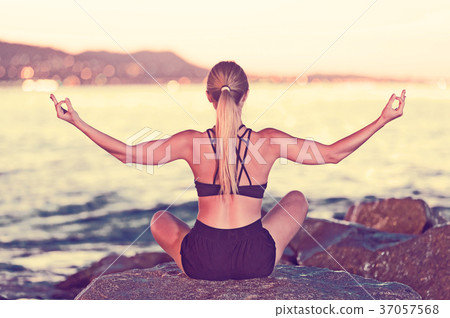 Young woman is meditating Young woman is meditating 37057568