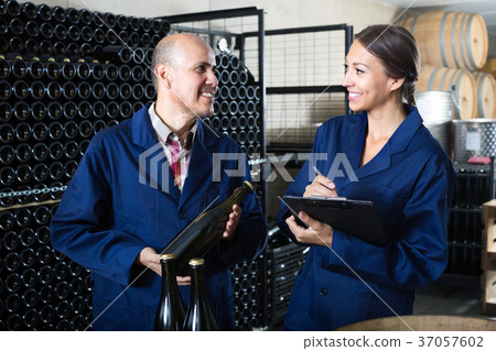 man and women winemakers with wine bottle. man and women winemakers with wine bottle. 37057602