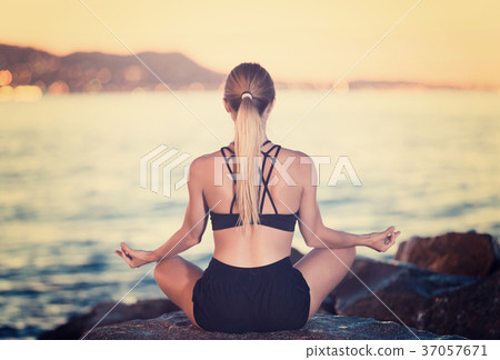 Female is meditating 37057671