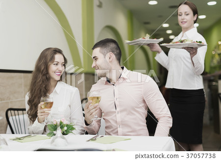 Female waiter serving guests table 37057738