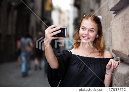 positive female making selfie in the city center positive female making selfie in the city center 37057752