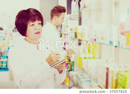 Pharmaceutist working in chemist shop Pharmaceutist working in chemist shop 37057820