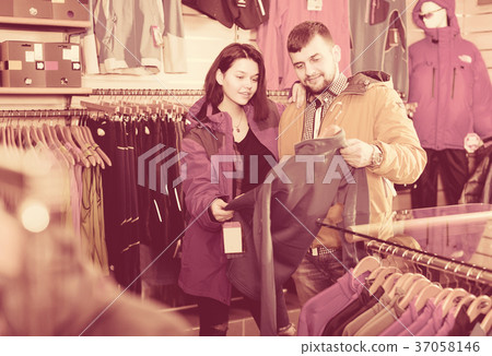 Couple deciding on track jacket Couple deciding on track jacket 37058146