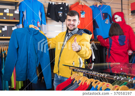 Couple choosing jacket in store Couple choosing jacket in store 37058197