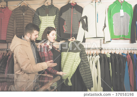 Couple looking for a windbreaker 37058198