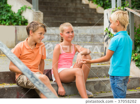 Two boys and girl are communicating on walk 37058202
