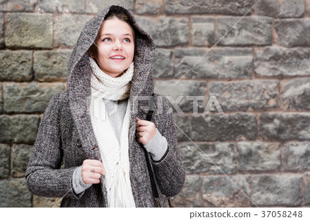teenager girl in hood near wall 37058248