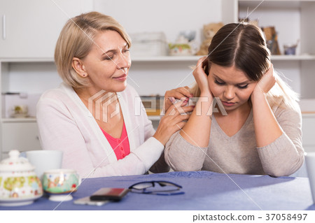 mother comforts her adult daughter 37058497