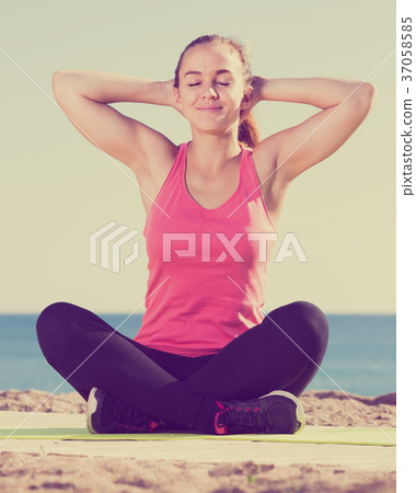 vigorous girl exercising on exercise mat outdoor vigorous girl exercising on exercise mat outdoor 37058585