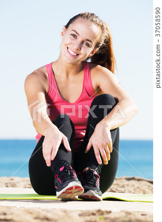 Woman doing yoga at beach Woman doing yoga at beach 37058590