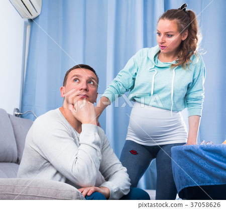 Husband and pregnant wife arguing at home Husband and pregnant wife arguing at home 37058626