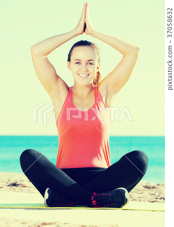 smiling girl exercising on exercise mat outdoor smiling girl exercising on exercise mat outdoor 37058632