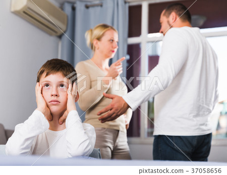 Sad boy during parents quarrel Sad boy during parents quarrel 37058656