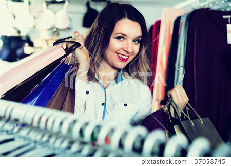 Female shopper boasting her purchases in underwear shop 37058745