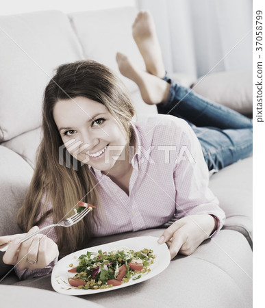 Girl eating green salad Girl eating green salad 37058799