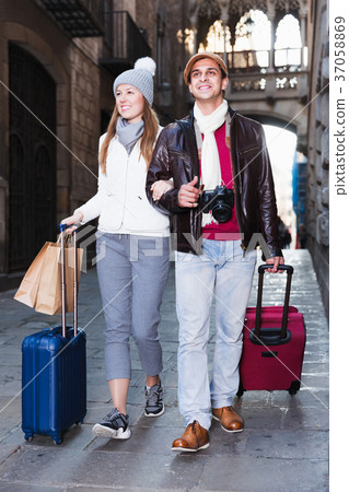 Couple walking with luggage 37058869