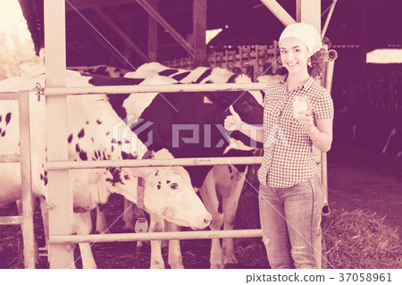 Portrait of female farm workers holding glass with milk Portrait of female farm workers holding glass with milk 37058961