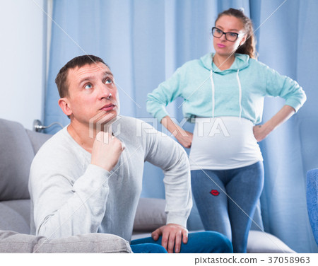 Husband and pregnant wife arguing at home Husband and pregnant wife arguing at home 37058963