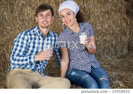 man and woman in hay with milk 37059032