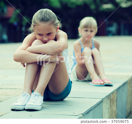 Two offended girls after quarrel outdoors Two offended girls after quarrel outdoors 37059075