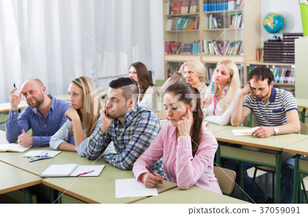 Tired students sitting at lesson 37059091