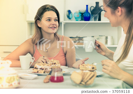 Young women are meeting for gossips on the kitchen 37059118