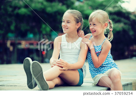 Two small sisters looking into distance Two small sisters looking into distance 37059254