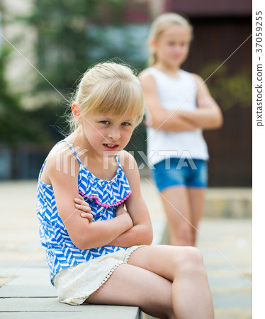 Two offended girls after quarrel outdoors Two offended girls after quarrel outdoors 37059255