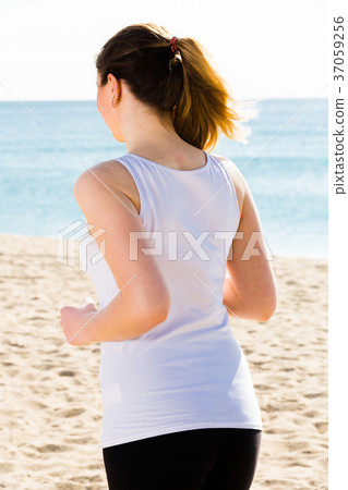 Woman running on beach Woman running on beach 37059256