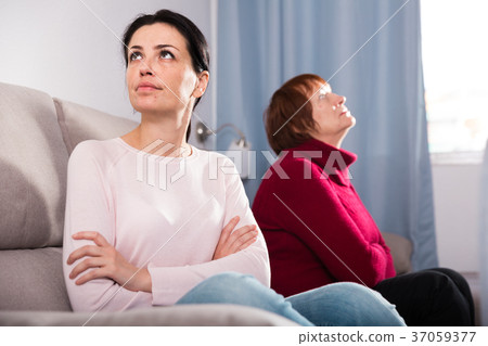 Portrait upset adult women looking away after conflict Portrait upset adult women looking away after conflict 37059377