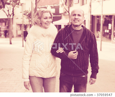 husband and blonde wife having a walk 37059547