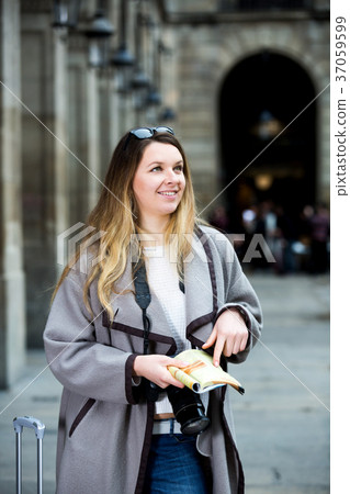 Woman having pamphlet and looking for her route 37059599