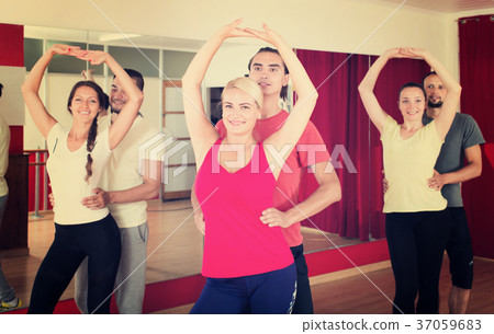 Smiling adults dancing bachata together i 37059683