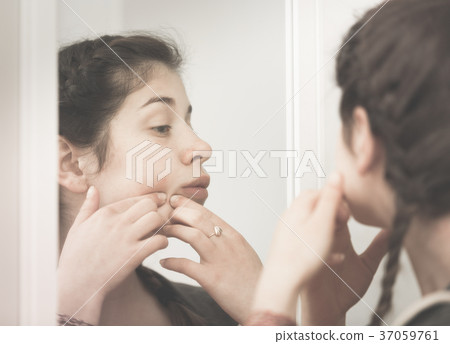 Girl cleaning pores 37059761