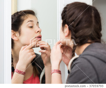 Girl cleaning pores 37059793