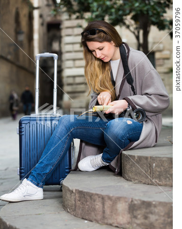 Blond glad girl holding brochure in hands 37059796