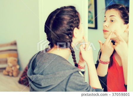 Girl cleaning pores 37059801