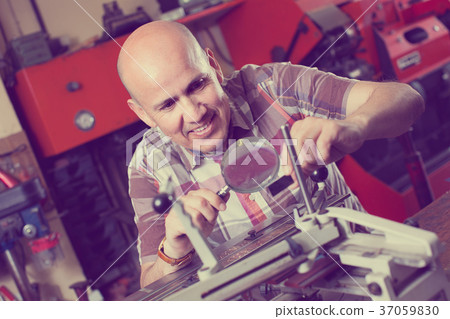 worker making nameboard worker making nameboard 37059830