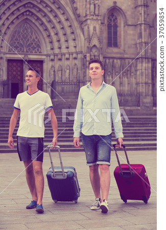 Men travelers with baggage heading to hotel 37059854