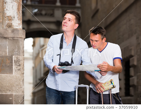interested men holding map in hands and looking for her way interested men holding map in hands and looking for her way 37059910