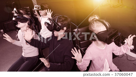 Enthusiastic children in virtual reality glasses in quest room 37060047