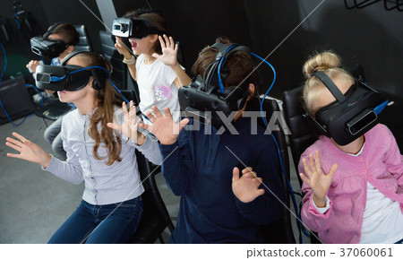 Enthusiastic children in virtual reality glasses in quest room 37060061