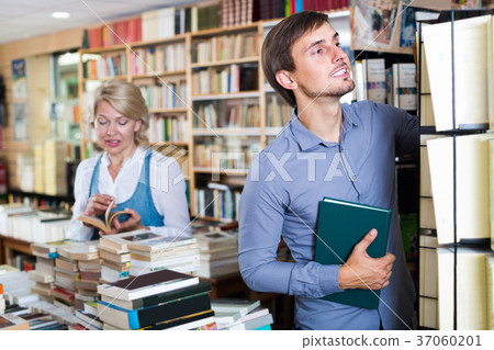 young man among bookshelves 37060201
