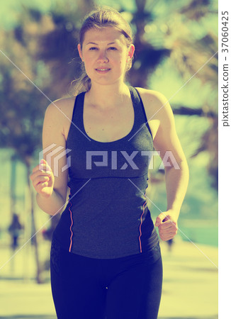 Woman jogging during outdoor workout 37060425