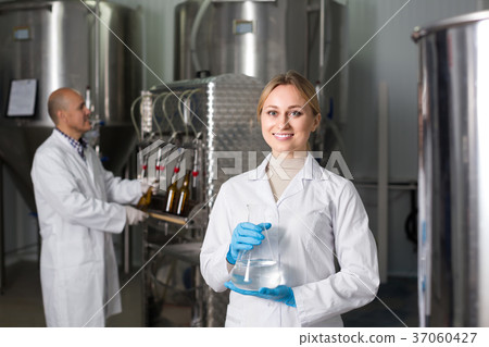 Two brewery workers on beer factory. Two brewery workers on beer factory. 37060427